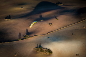 Paraglider over Andalusian landscape in the evening light at Algodonales, aerial view, Cadiz province, Spain Paraglider over Andalusian landscape in the evening light at Algodonales, aerial view, Cadiz province, Spain